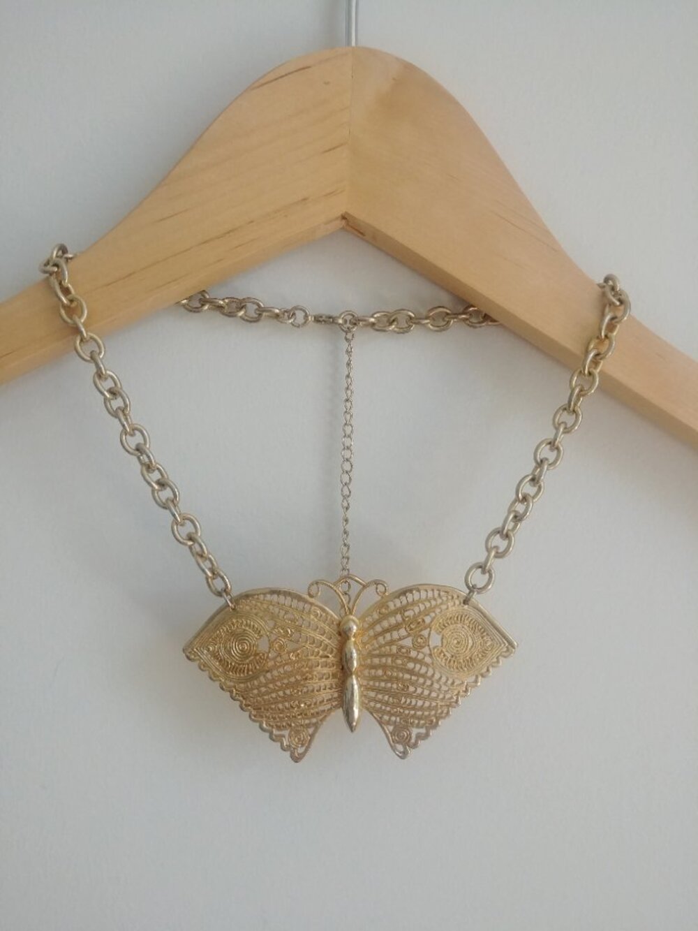 Large intricate butterfly pale gold tone short statement necklace